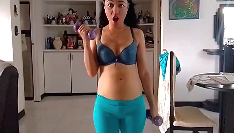 A cute brunette in lingerie is stripping naked and showing her body