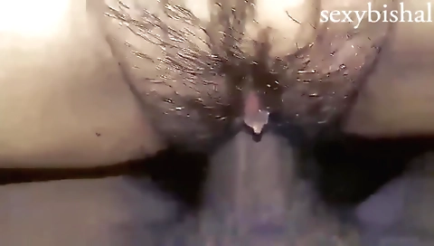 Hairy Indian girl in a black tunic and blue shorts