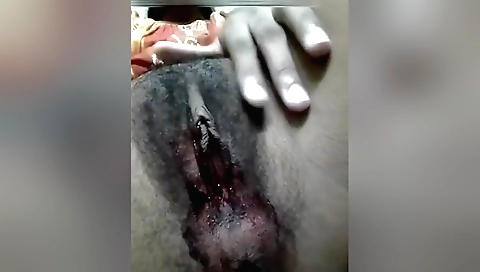 Busty brunette shows her hairy pussy in the camera vid